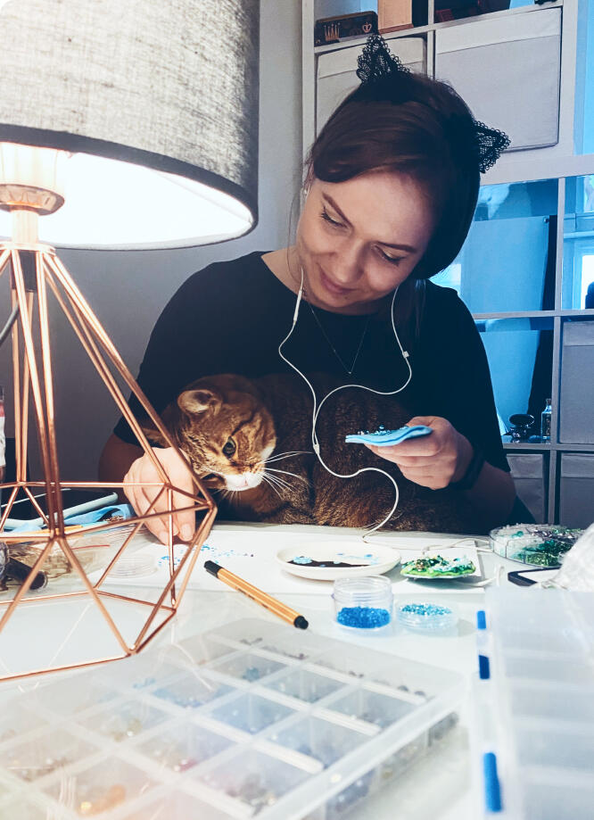 Photo of Olya with a brooch Olya says: "I'm passionate about making brooches and would love to create one especially for you!"