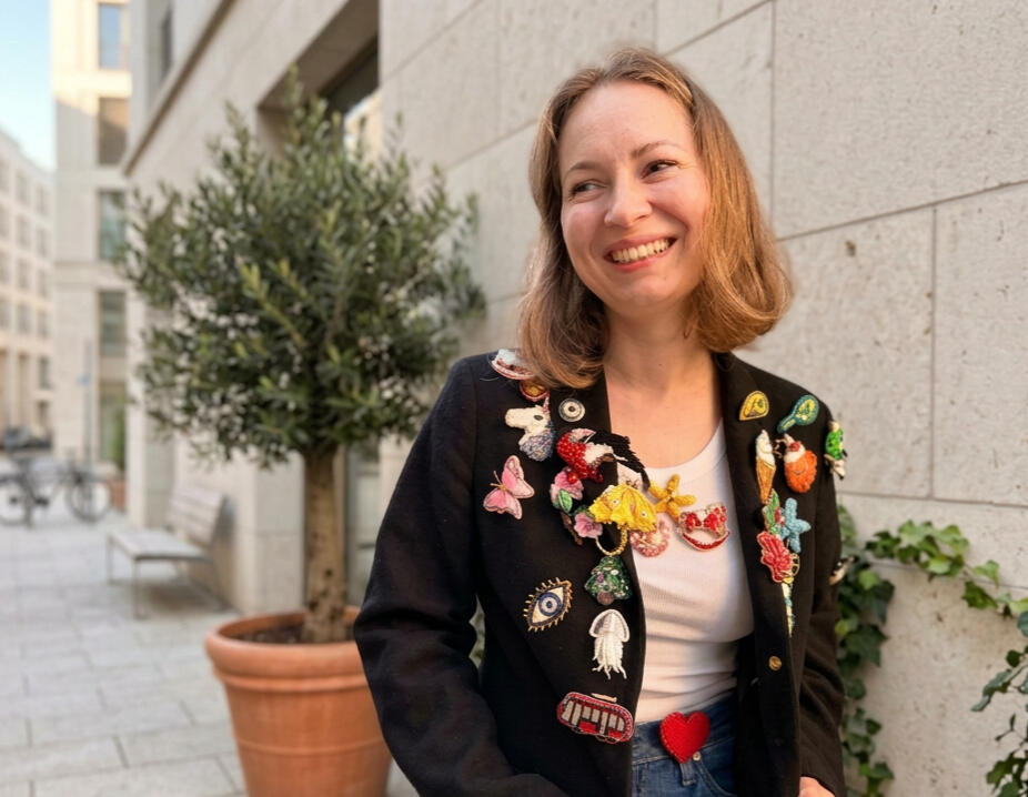 Stylish photo with a brooch A brooch on the sleeve of a stylish woman's jacket in the city.